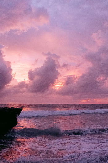 Breathtaking pink sunset over Bali's ocean with dramatic clouds and waves. HD phone wallpaper