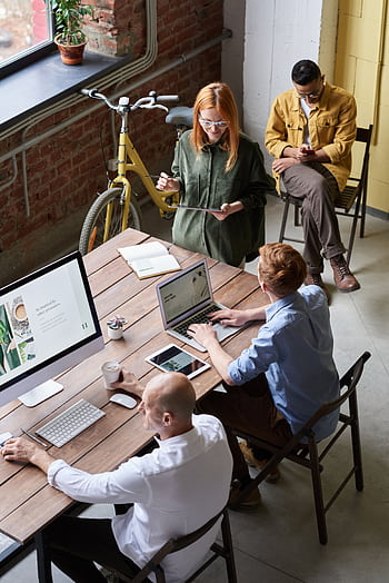 Casual workspace with diverse team working and interacting in a modern office. HD phone wallpaper