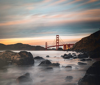 Bridge, architecture, rocks, sunset, coast HD wallpaper