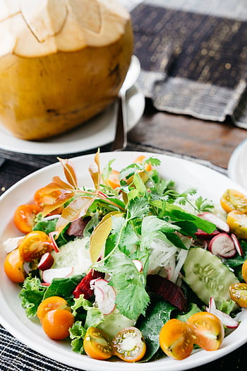 Healthy fresh salad with cucumbers, tomatoes, and tropical coconut in Bali. HD phone wallpaper