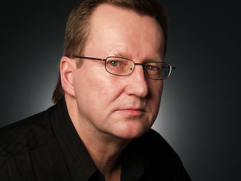 Close-up portrait of a serious businessman in eyeglasses against a dark background. HD wallpaper
