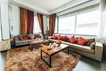 Stylish living room with contemporary furniture, colorful curtains, and cozy atmosphere, perfect for modern home interiors. HD wallpaper