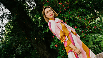 Stylish Girl Model Elizabeth Olsen Is Standing In Red Flowers Green Leaves Plants Background Wearing Colorful Dress Girls HD wallpaper