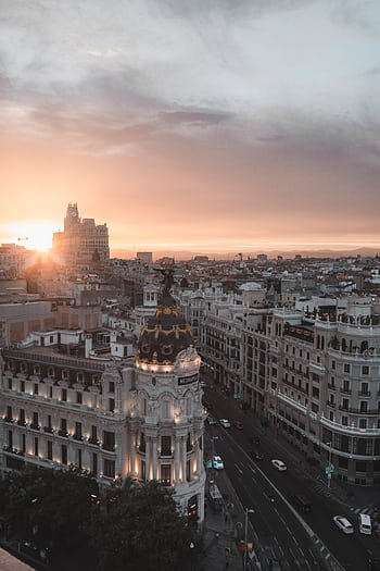 Stunning view of Madrid cityscape with sunset over the Metropolis Building. HD phone wallpaper