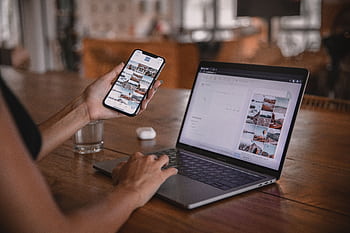 Woman edits social media content on and laptop at a cafe in Bali. HD wallpaper