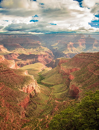 Breathtaking panoramic view of the Grand Canyon under dramatic skies. HD phone wallpaper