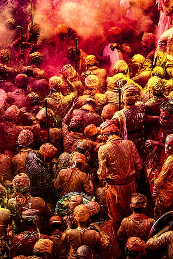 Colorful crowd celebrating Holi with vibrant powders in India. HD phone wallpaper