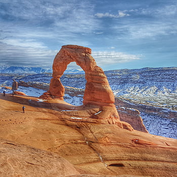 Delicate Arch in Moab, Utah, showcased against a winter landscape. Perfect for travel and nature enthusiasts. HD phone wallpaper