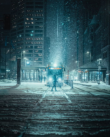 A snowy night scene with tram in downtown Minneapolis, highlighting urban winter charm. HD phone wallpaper
