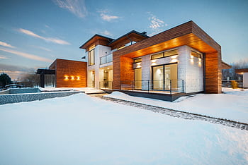 Contemporary wooden house exterior in snowy setting, perfect for real estate listings. HD wallpaper
