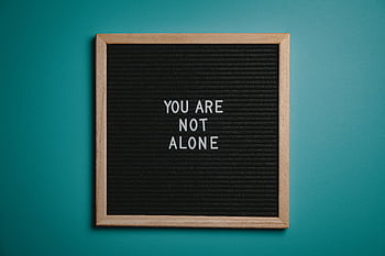 A wooden letter board displays a motivational message against a teal background. HD wallpaper