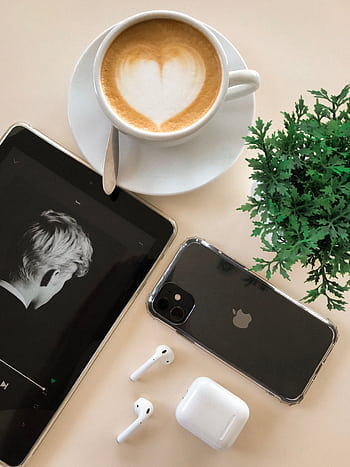 A stylish flat lay showcasing a coffee cup, gadgets, AirPods, and a plant for a modern lifestyle vibe. HD phone wallpaper