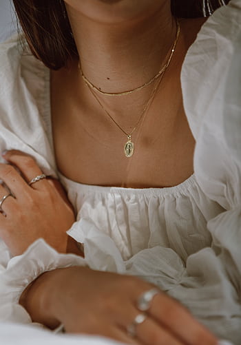 Close-up of a woman wearing a white dress and gold jewelry, showcasing elegance and style. HD phone wallpaper