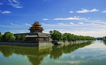 Beautiful view of the Forbidden City's corner tower with its reflection in water and a clear blue sky. HD wallpaper