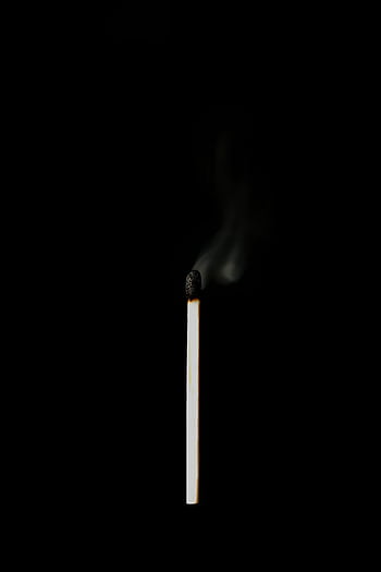 A single burnt matchstick with smoke rising against a dark background. HD phone wallpaper