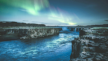 Body Of Water Between Rock Formation, water, rock, mountain, mountains, snow, sky, stars, aurora, nature HD wallpaper
