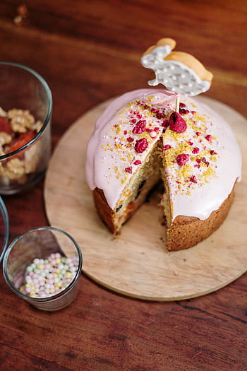 Delicious homemade Easter cake with bunny decor and vibrant topping on a wooden table. HD phone wallpaper