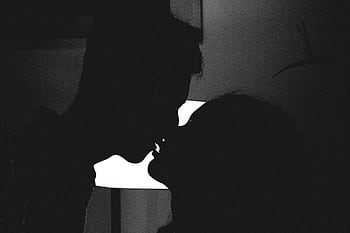 Silhouette of a couple kissing in a romantic and intimate moment against a bright light. HD wallpaper