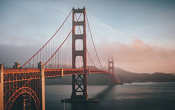 Golden Gate Bridge shrouded in fog during sunset, San Francisco. HD wallpaper
