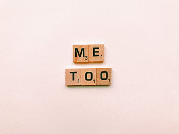 Wooden tiles spelling 'Me Too' on a plain background, symbolizing empowerment. HD wallpaper