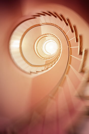 A mesmerizing spiral staircase captured in a soft blur, creating a dreamy effect. HD phone wallpaper