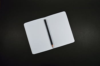 Top view of an open blank notebook with a pencil on a black background, perfect for creative projects. HD wallpaper