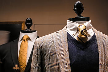 Sophisticated men's suits and ties displayed on mannequins in a stylish boutique setting. HD wallpaper