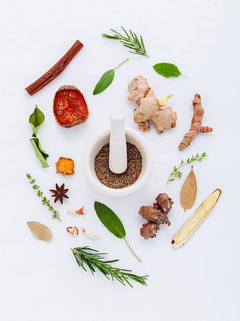 A flat lay of diverse spices and herbs surrounding a mortar and pestle on a white background. HD phone wallpaper