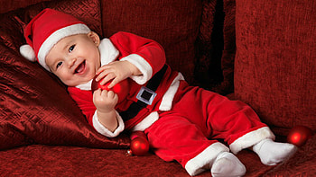 Beautiful Cute Smiling Baby Is Wearing Santa Claus Red Dress Cap Lying Down On Dark Maroon Cloth Cute HD wallpaper