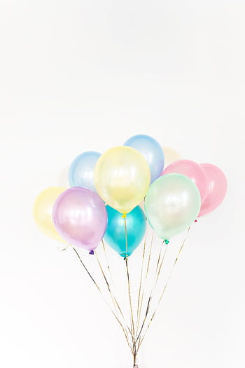 A vibrant cluster of pastel balloons with white background, ideal for celebrations. HD phone wallpaper