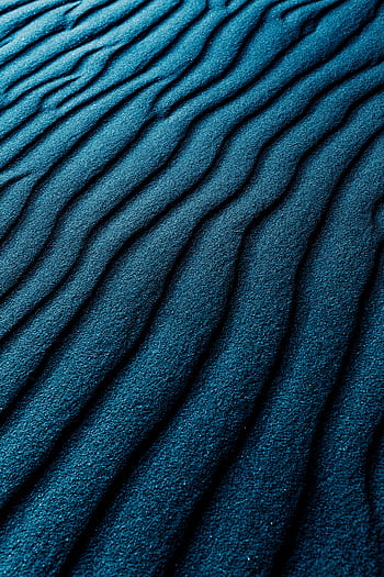 Close-up of dark blue textured sand dunes with a wavy pattern, perfect for backgrounds. HD phone wallpaper