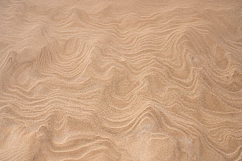 Close-up view of rippled sand texture at Leba Beach, Poland, showcasing natural patterns. HD wallpaper