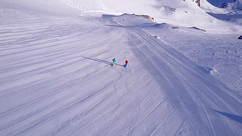 Aerial view skiing couple, Snowy resort escapade, Stock video footage, Winter romance HD wallpaper