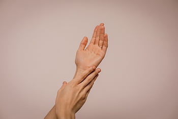 Close-up of hands gently caressing each other, symbolizing self-care and softness. HD wallpaper