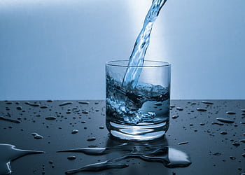 High-quality of water being poured into a glass, illustrating hydration and purity. HD wallpaper