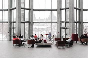 Spacious lounge with modern decor and large windows showcasing a snowy Ottawa view. HD wallpaper