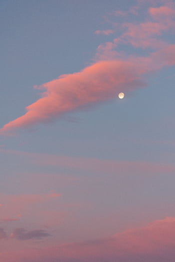 A serene pink sky at sunset featuring a softly glowing moon amidst wispy clouds. HD phone wallpaper