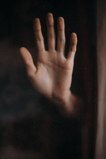 A close-up of an open human hand against a glass window, creating a feeling of separation. HD phone wallpaper