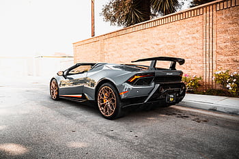A sleek Lamborghini sports car parked in an urban setting, showcasing luxury automotive design. HD wallpaper