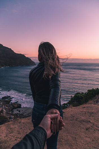 Young couple holding hands by the ocean with a stunning sunset view in Cape Town. HD phone wallpaper