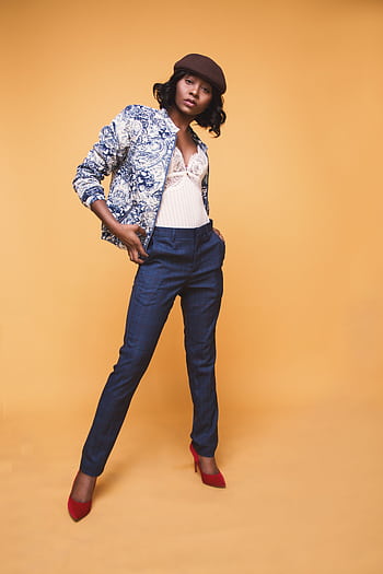 Stylish African American woman posing confidently in studio setting. HD phone wallpaper
