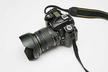Close-up of a DSLR camera with a lens and strap, ideal for graphy equipment themes. HD wallpaper