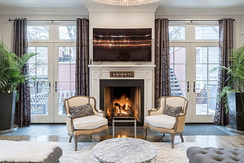Stylish and contemporary living room featuring a cozy fireplace and elegant furniture. HD wallpaper