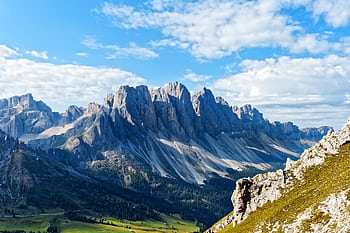 A breathtaking view of a majestic mountain range under a clear blue sky, perfect for nature enthusiasts. HD wallpaper