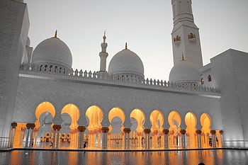 Stunning view of Sheikh Zayed Mosque with illuminated arches and domes during dusk. HD wallpaper