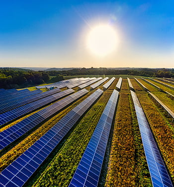 Aerial view of a solar farm in Red Wing, MN, with solar panels harnessing the sun's energy. HD phone wallpaper