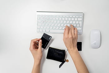 E-commerce setup featuring a keyboard, card, and wallet, ideal for online shopping concepts. HD wallpaper