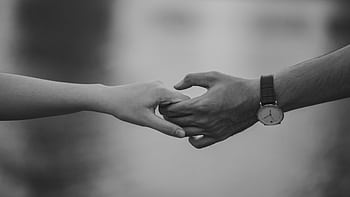 Monochrome of two hands holding, symbolizing love and connection. HD wallpaper