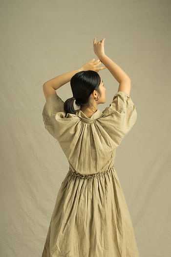 Elegant Asian woman posing gracefully in a vintage style dress. HD phone wallpaper