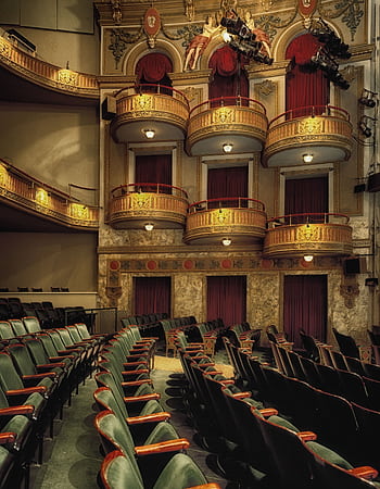 Classic theater interior featuring ornate balconies and empty seats, perfect for drama or performance themes. HD phone wallpaper